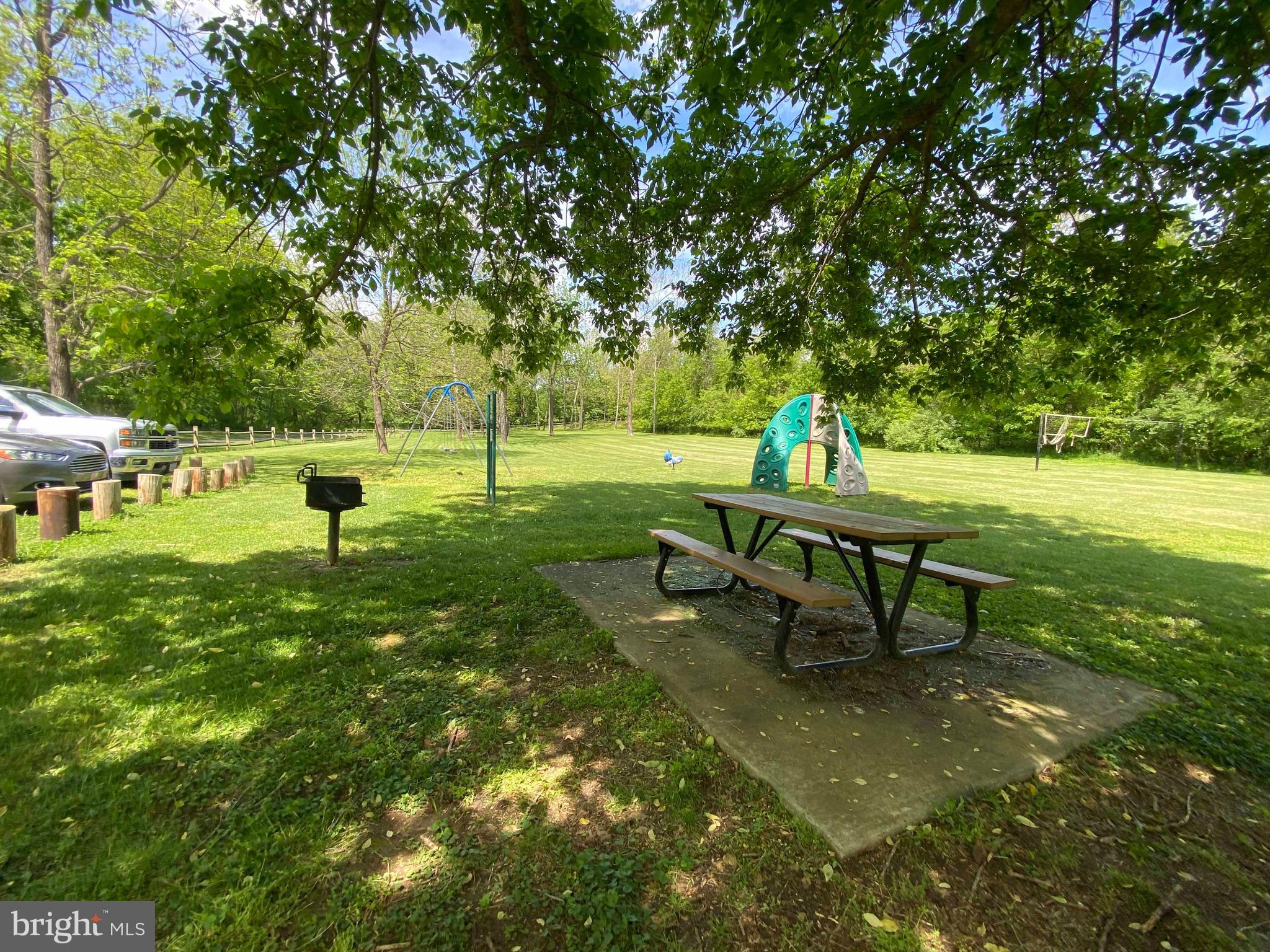 458 Hobbs Knob Road Front Royal, VA 22630 - Photo 63 of 94 a view of a bench in the garden near a lake