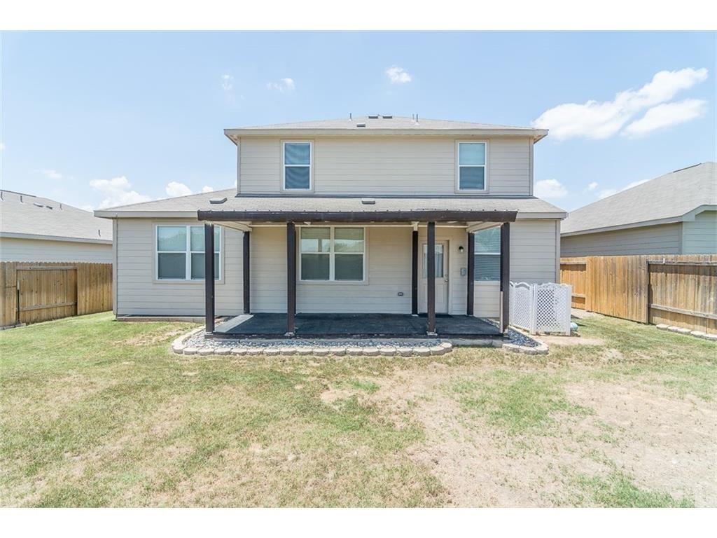 1009 Hawthorne Road Anna, TX 75409 - Photo 21 of 22 Rear exterior featuring a covered patio with dark columns and a dark flooring surface