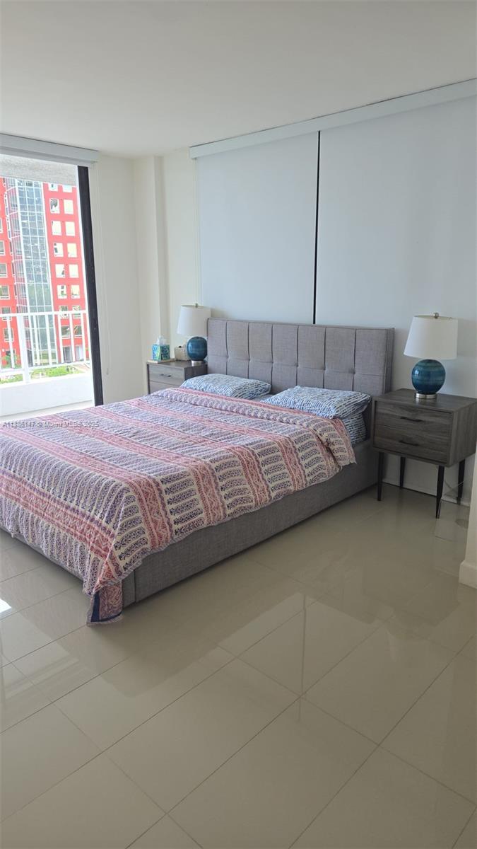 200 Southeast 15th Road, Unit 8J Miami, FL 33129 - Photo 11 of 20 a bedroom with a bed and wooden floor