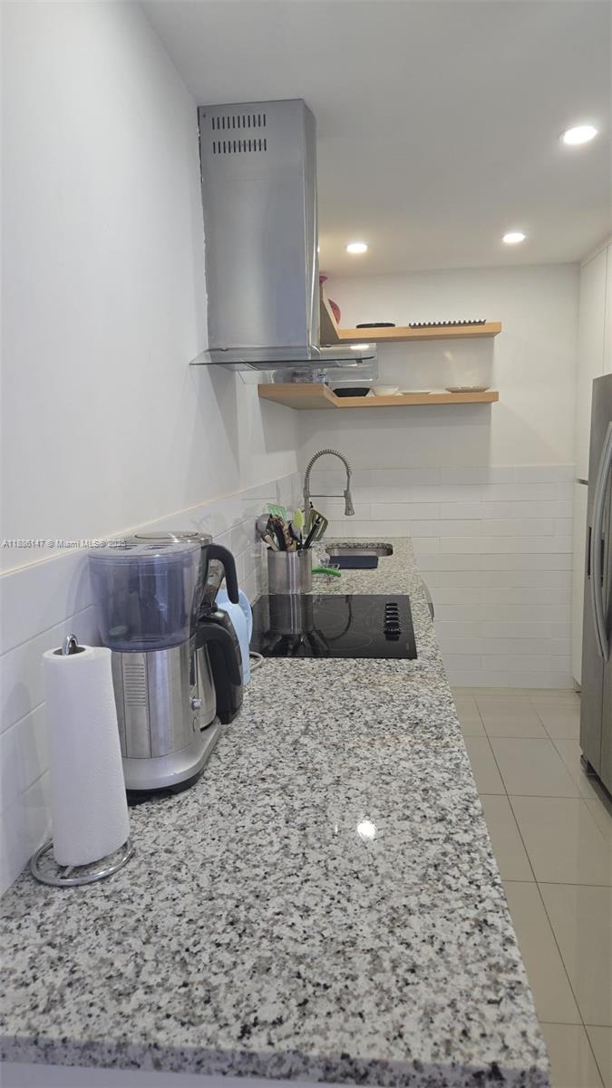200 Southeast 15th Road, Unit 8J Miami, FL 33129 - Photo 12 of 20 a kitchen with a sink and cabinets