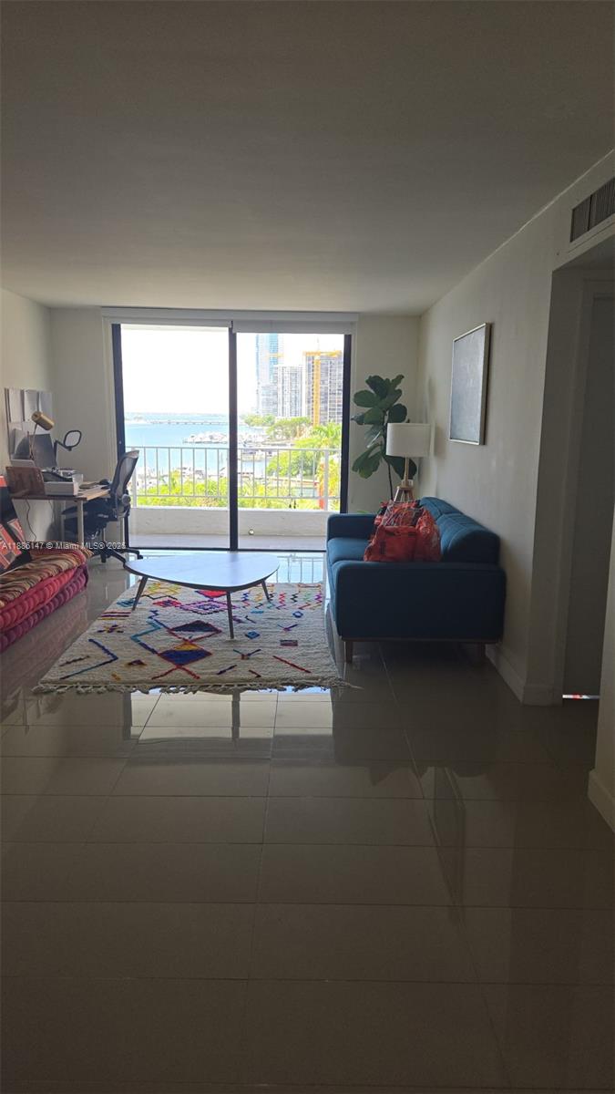 200 Southeast 15th Road, Unit 8J Miami, FL 33129 - Photo 4 of 20 a spacious bedroom with a bed and a large window