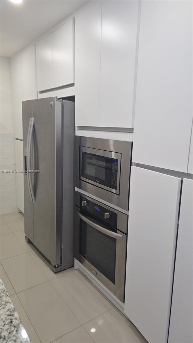200 Southeast 15th Road, Unit 8J Miami, FL 33129 - Photo 6 of 20 a metallic refrigerator freezer a stove sitting inside of a kitchen