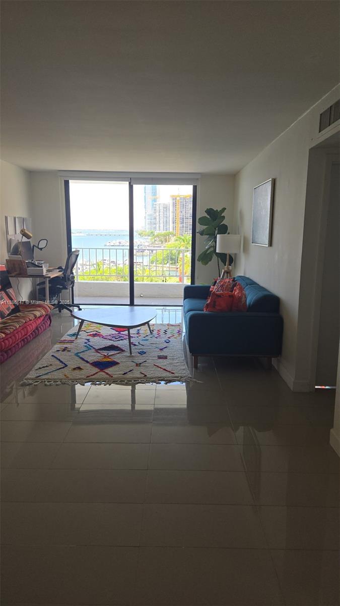 200 Southeast 15th Road, Unit 8J Miami, FL 33129 - Photo 7 of 20 a bed room with a bed and a large window