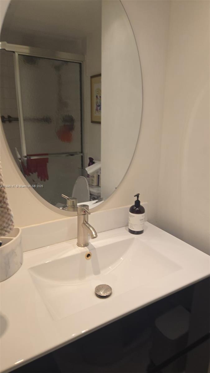 200 Southeast 15th Road, Unit 8J Miami, FL 33129 - Photo 8 of 20 a bathroom with a sink and a mirror