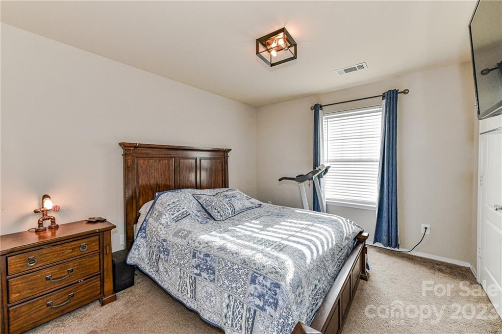 319 River Clay Road Fort Mill, SC 29708 - Photo 17 of 27 a bedroom with a bed and a lamp on the dresser