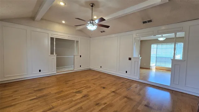 wooden floor in an empty room with a window