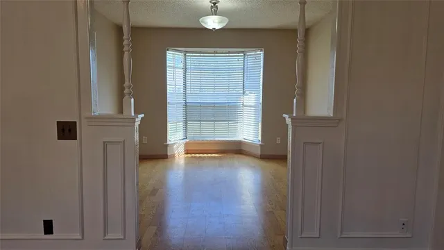 wooden floor in an empty room and a window