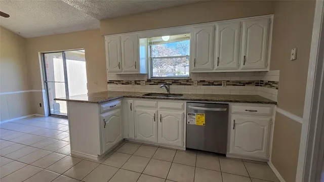 a kitchen with a sink stove and cabinets