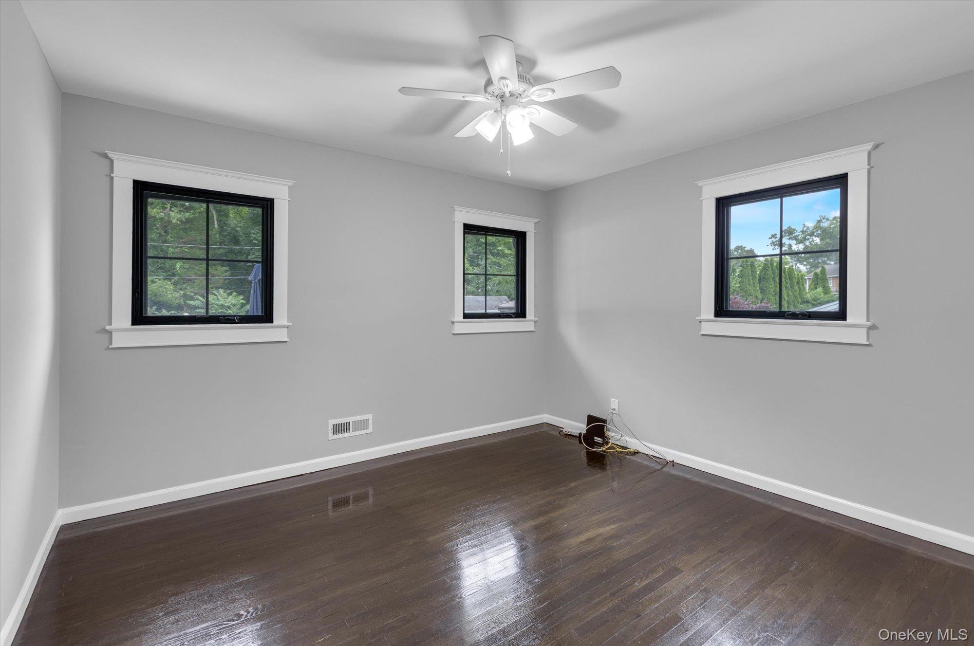 31 Apple Lane Commack, NY 11725 - Photo 13 of 28 Second bedroom on first level with wood flooring and plenty of windows to let in natural light.