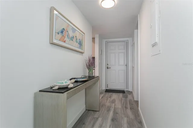 a kitchen with cabinets and wooden floor