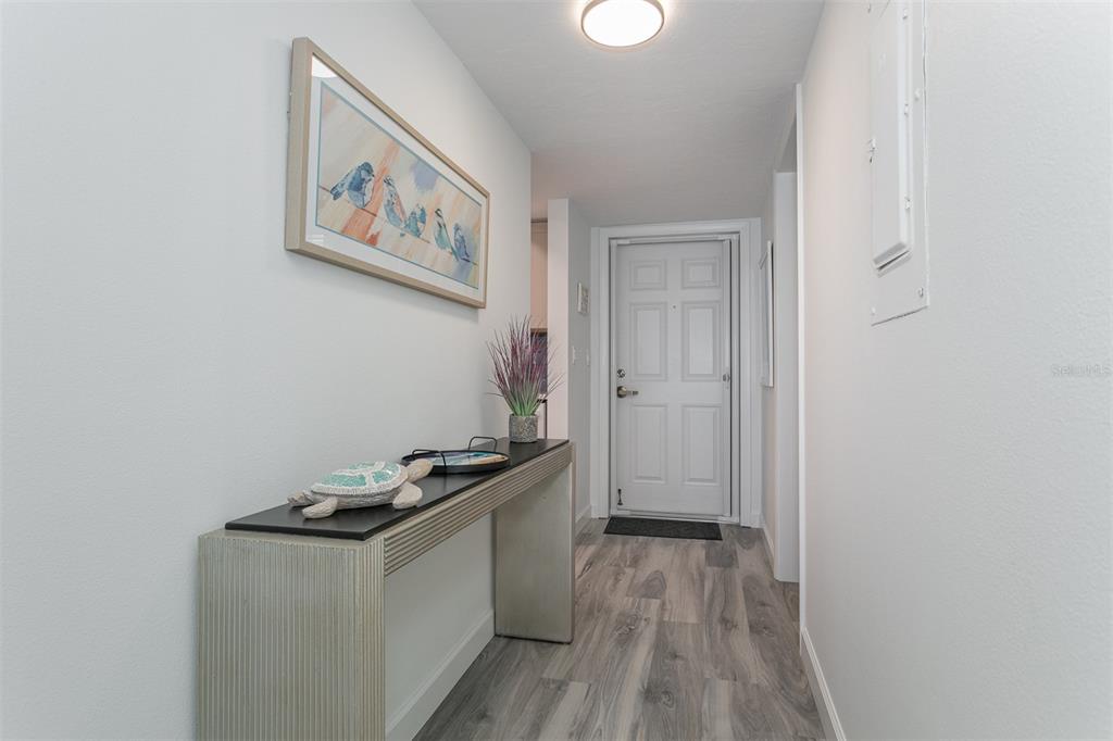 633 Alhambra Road, Unit 305 Venice, FL 34285 - Photo 12 of 43 a view of a hallway with wooden floor