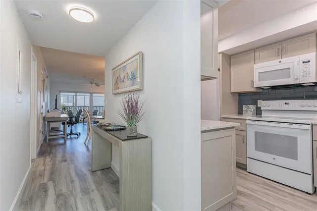 a kitchen with refrigerator a sink and cabinets