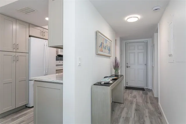 a kitchen with white cabinets and sink