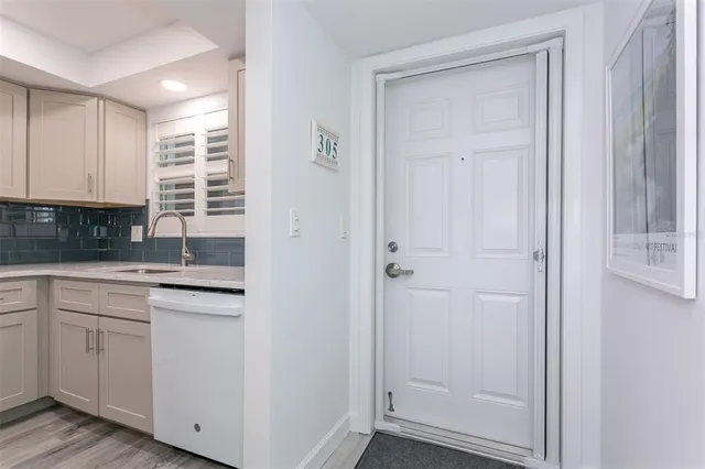 a kitchen with granite countertop white cabinets and white appliances