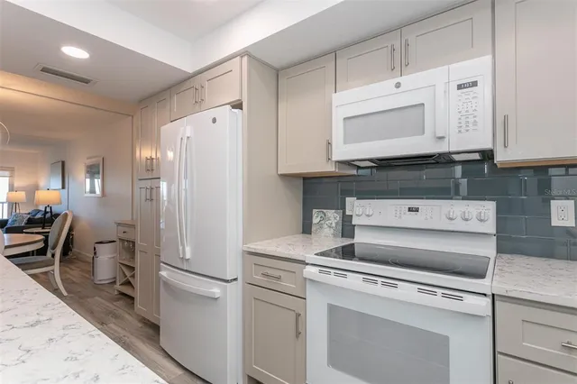 a kitchen with a stove oven and cabinets