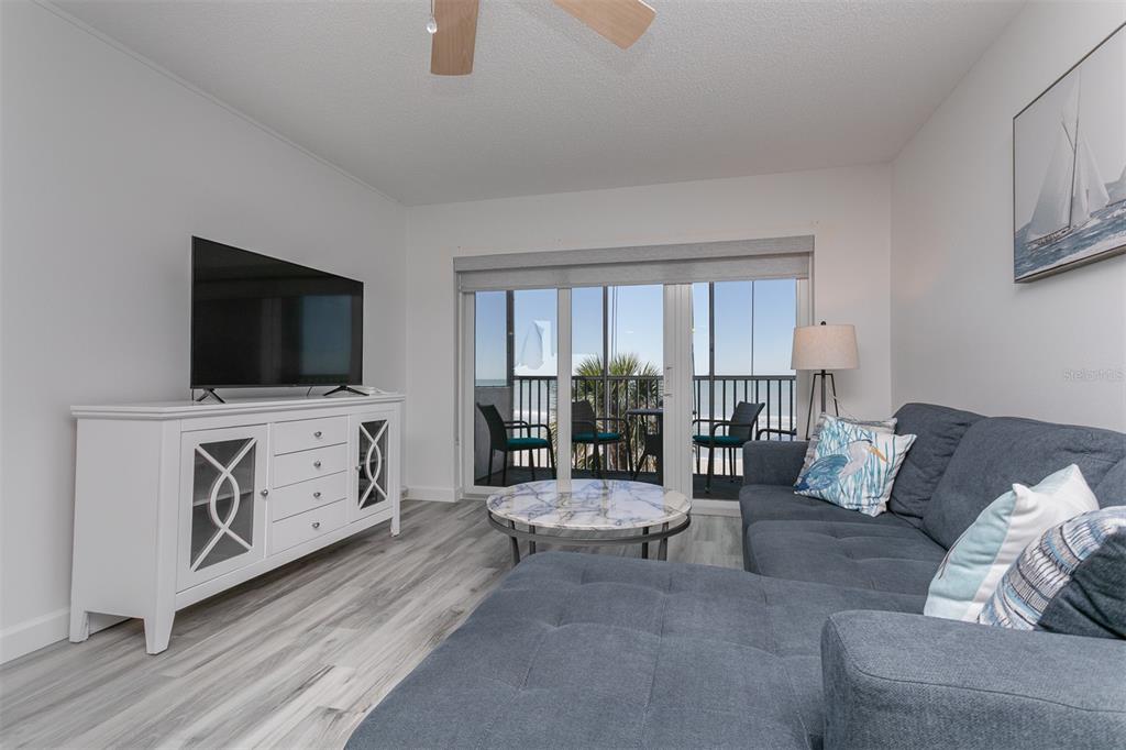 633 Alhambra Road, Unit 305 Venice, FL 34285 - Photo 25 of 43 a living room with furniture and a flat screen tv