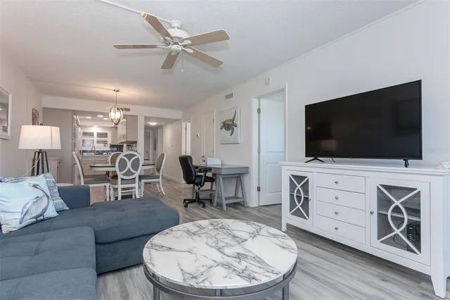 a living room with furniture a table and a lamp