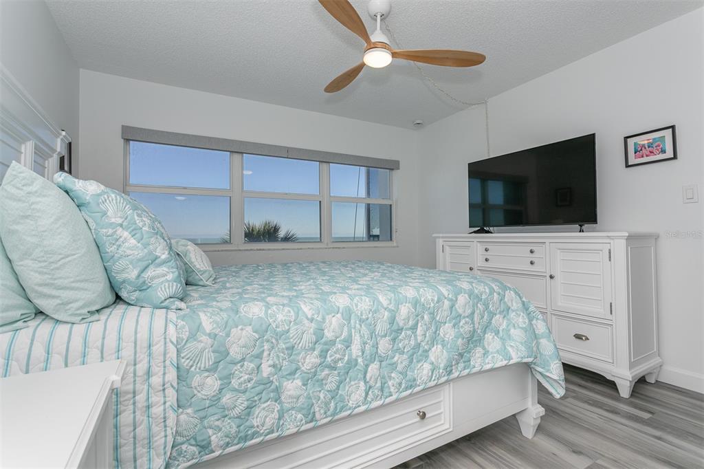 633 Alhambra Road, Unit 305 Venice, FL 34285 - Photo 29 of 43 a bedroom with a bed and a flat screen tv