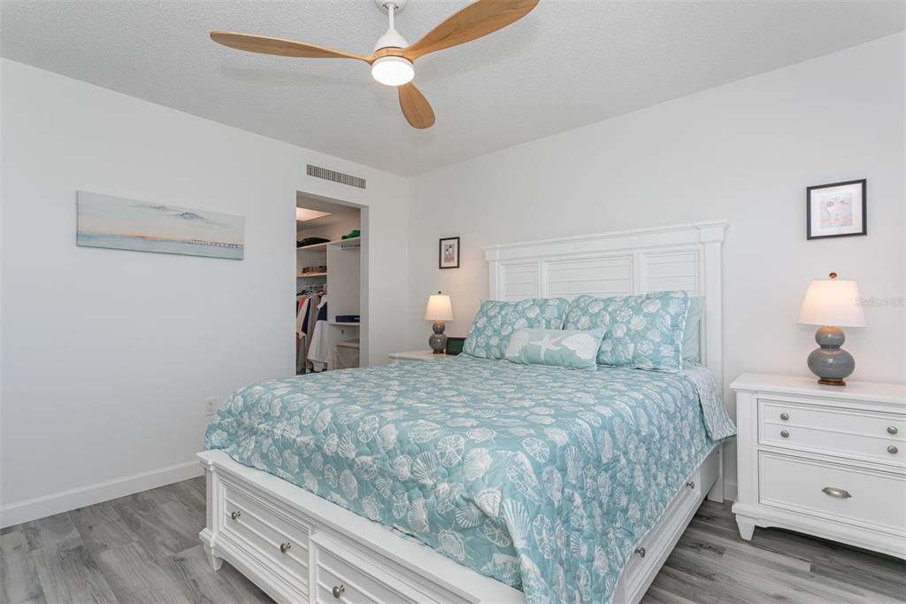 633 Alhambra Road, Unit 305 Venice, FL 34285 - Photo 31 of 43 a bedroom with a bed and a chandelier