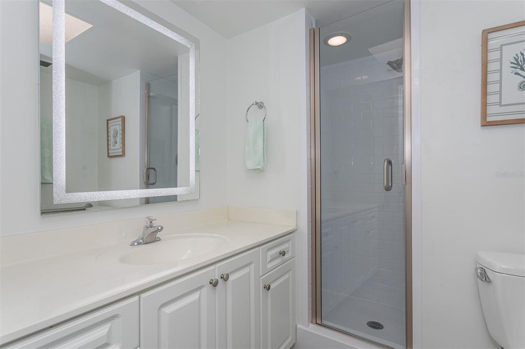 633 Alhambra Road, Unit 305 Venice, FL 34285 - Photo 34 of 43 a bathroom with a sink a toilet and shower