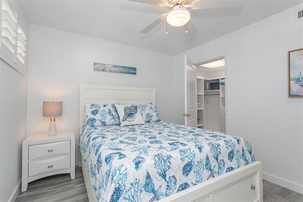 633 Alhambra Road, Unit 305 Venice, FL 34285 - Photo 37 of 43 a bedroom with a bed and a chandelier