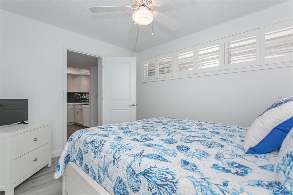 633 Alhambra Road, Unit 305 Venice, FL 34285 - Photo 38 of 43 a bedroom with a bed and a flat screen tv