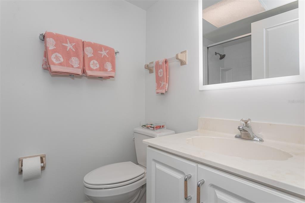 633 Alhambra Road, Unit 305 Venice, FL 34285 - Photo 40 of 43 a bathroom with a sink mirror vanity and toilet