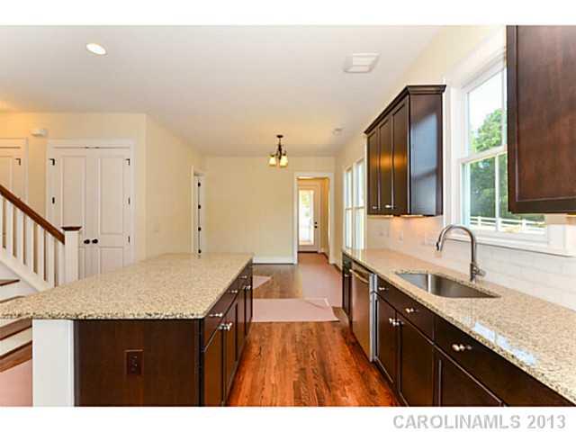808 Elswick Court, Unit 1332 Fort Mill, SC 29708 - Photo 8 of 16 a kitchen with granite countertop a sink dishwasher stove and cabinets