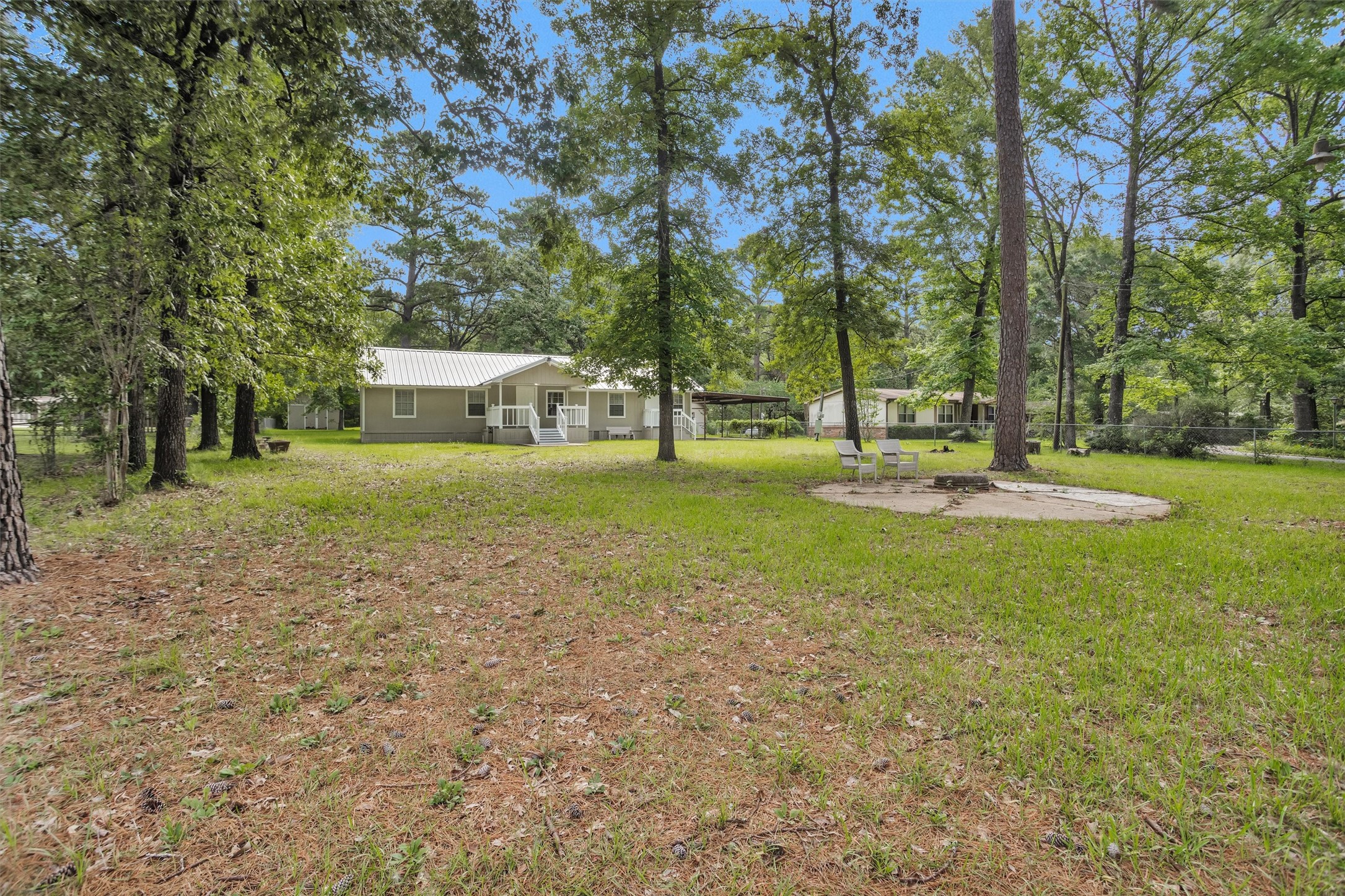 99 Main Street Huntsville, TX 77340 - Photo 2 of 47 Charming single-story home with a spacious yard surrounded by mature trees.