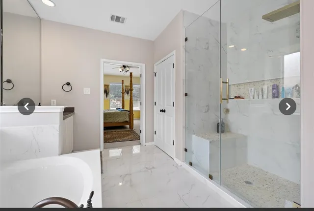 a bathroom with a bathtub and a shower
