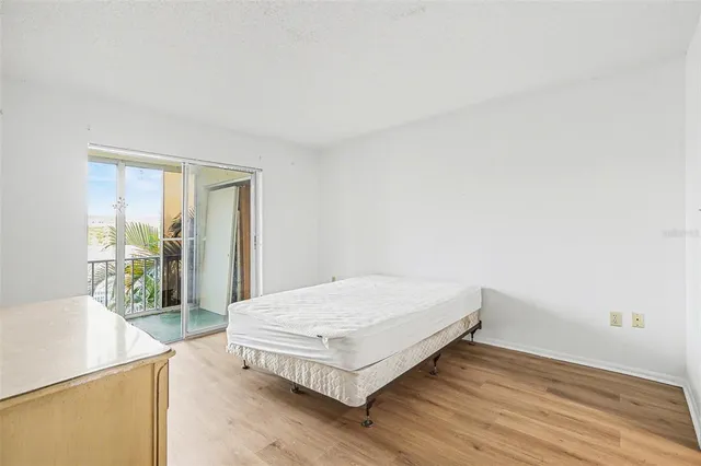 a living room with a bed and next to a window with outer view