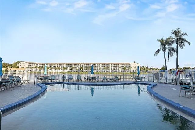 a view of a lake with a table and chairs