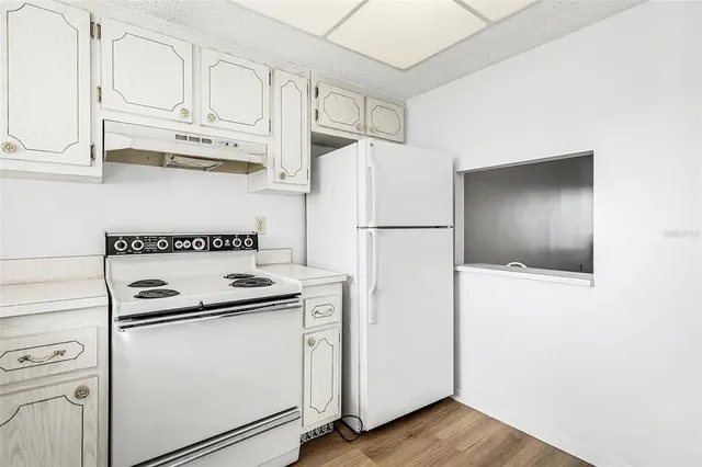 a white refrigerator freezer sitting inside of a kitchen