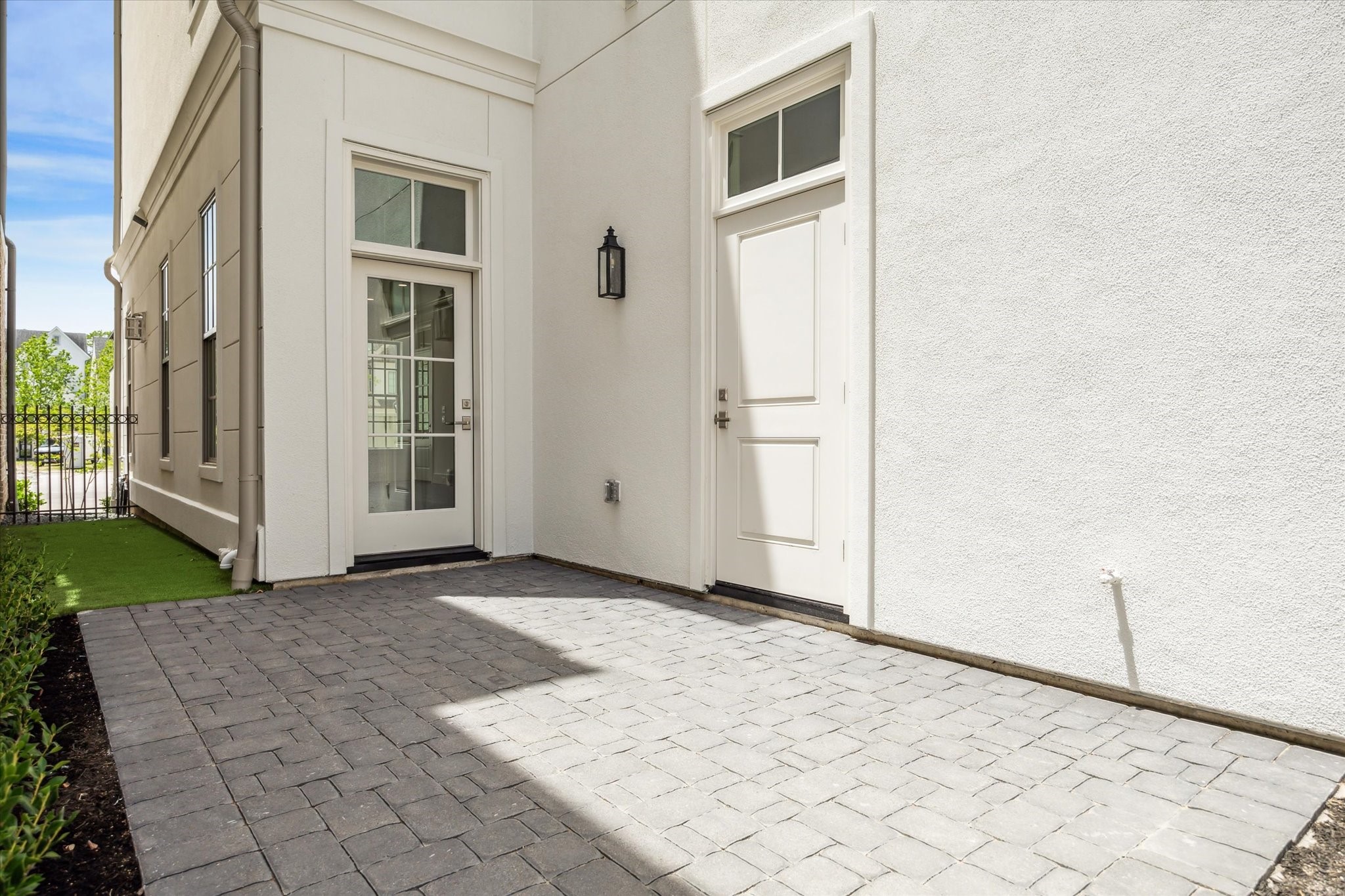 209 Sutton Row Place Houston, TX 77024 - Photo 7 of 23 Private courtyard features patio and artificial turf, accessible from glass door in house, side door to garage and back gate from curb.