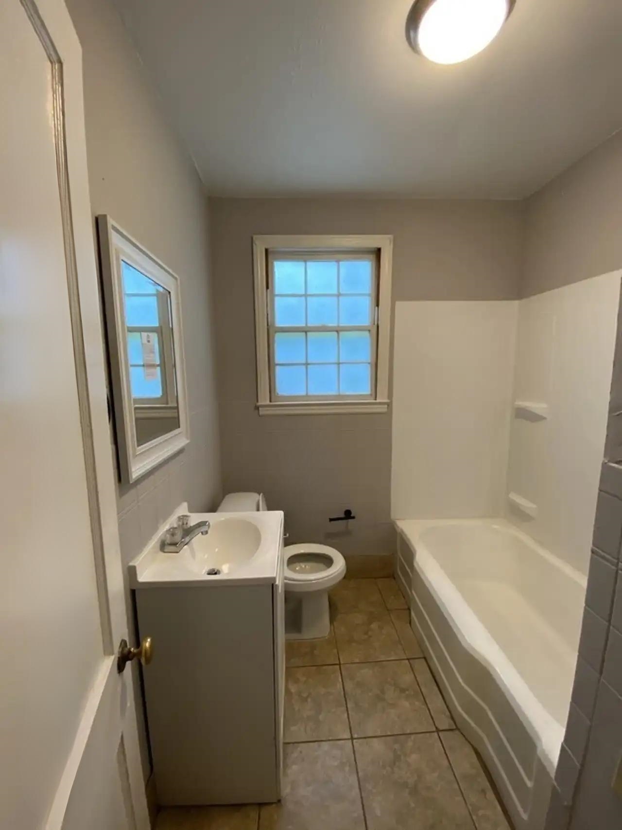 494 East Raines Road Memphis, TN 38109 - Photo 2 of 9 Bathroom with vanity, a bathtub, and tile patterned flooring