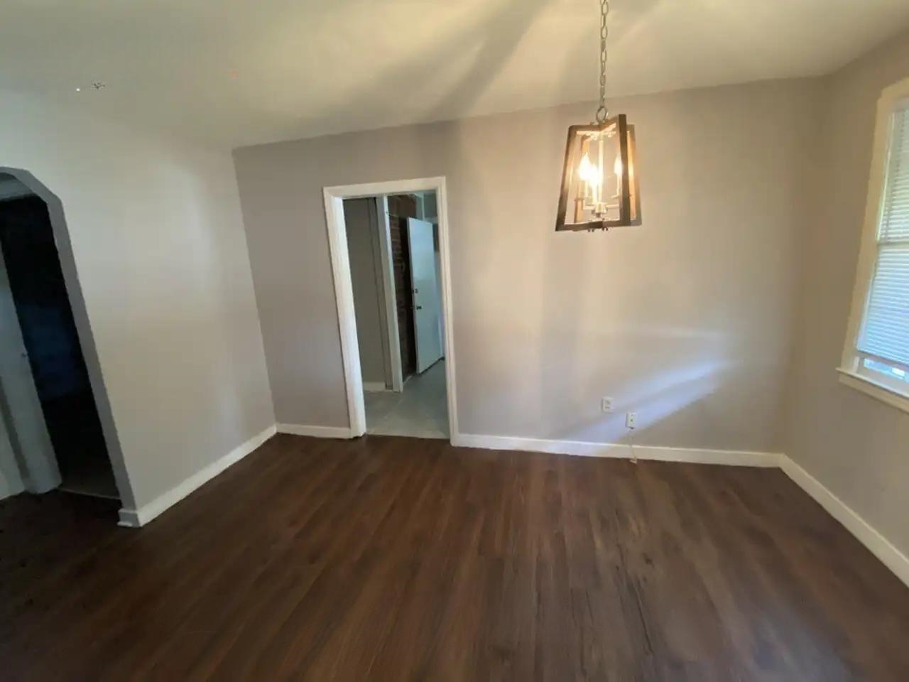 494 East Raines Road Memphis, TN 38109 - Photo 3 of 9 Unfurnished dining area with dark wood-type flooring and arched walkways