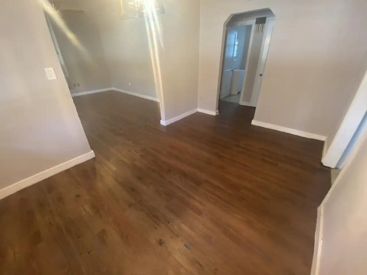 494 East Raines Road Memphis, TN 38109 - Photo 9 of 9 Empty room featuring arched walkways and wood finished floors