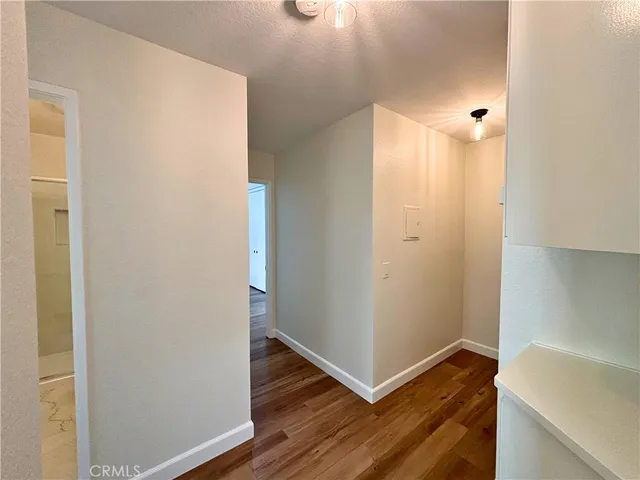 a view of a hallway with wooden floor