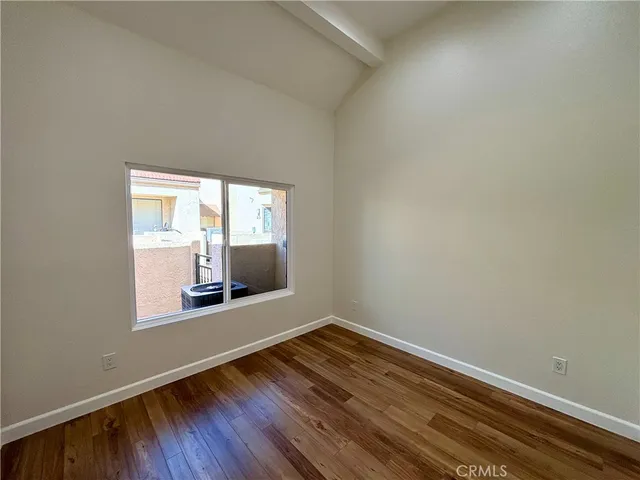 a view of wooden floor and windows in a room