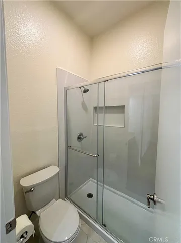 a bathroom with a toilet and a shower