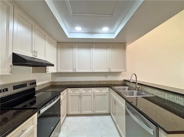 a kitchen with a sink stove and cabinets