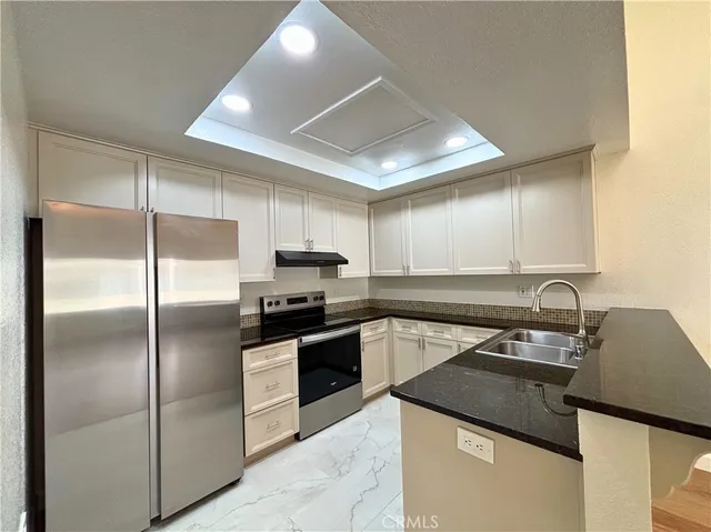 a kitchen with a sink stainless steel appliances and cabinets