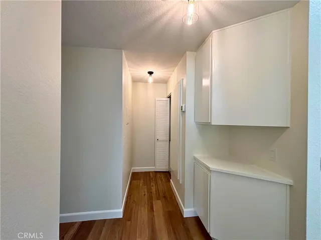 a view of a hallway with wooden floor