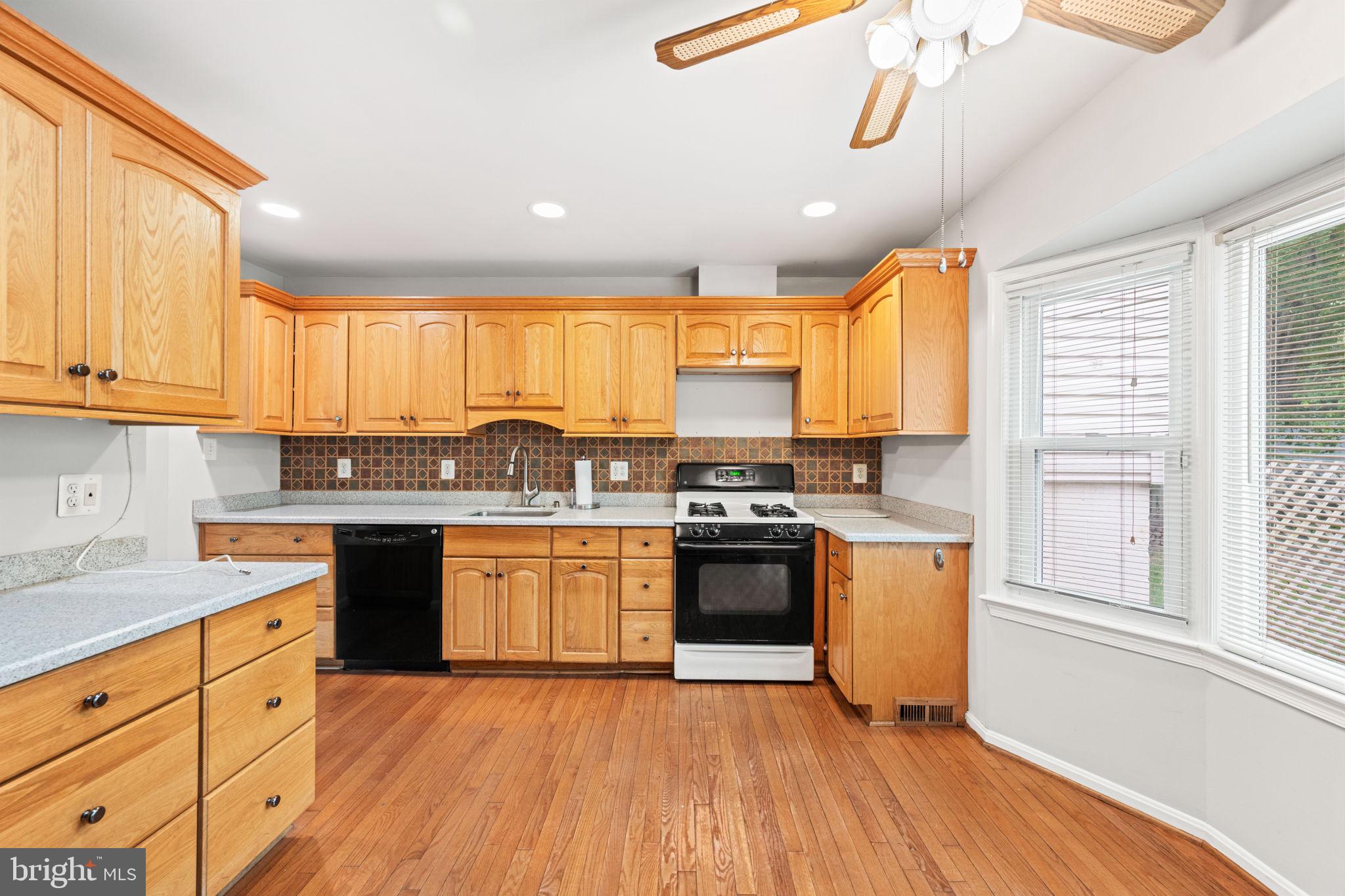 8000 Lady Lewis Court Springfield, VA 22153 - Photo 12 of 44 a kitchen with stainless steel appliances granite countertop a sink a stove cabinets and wooden floor