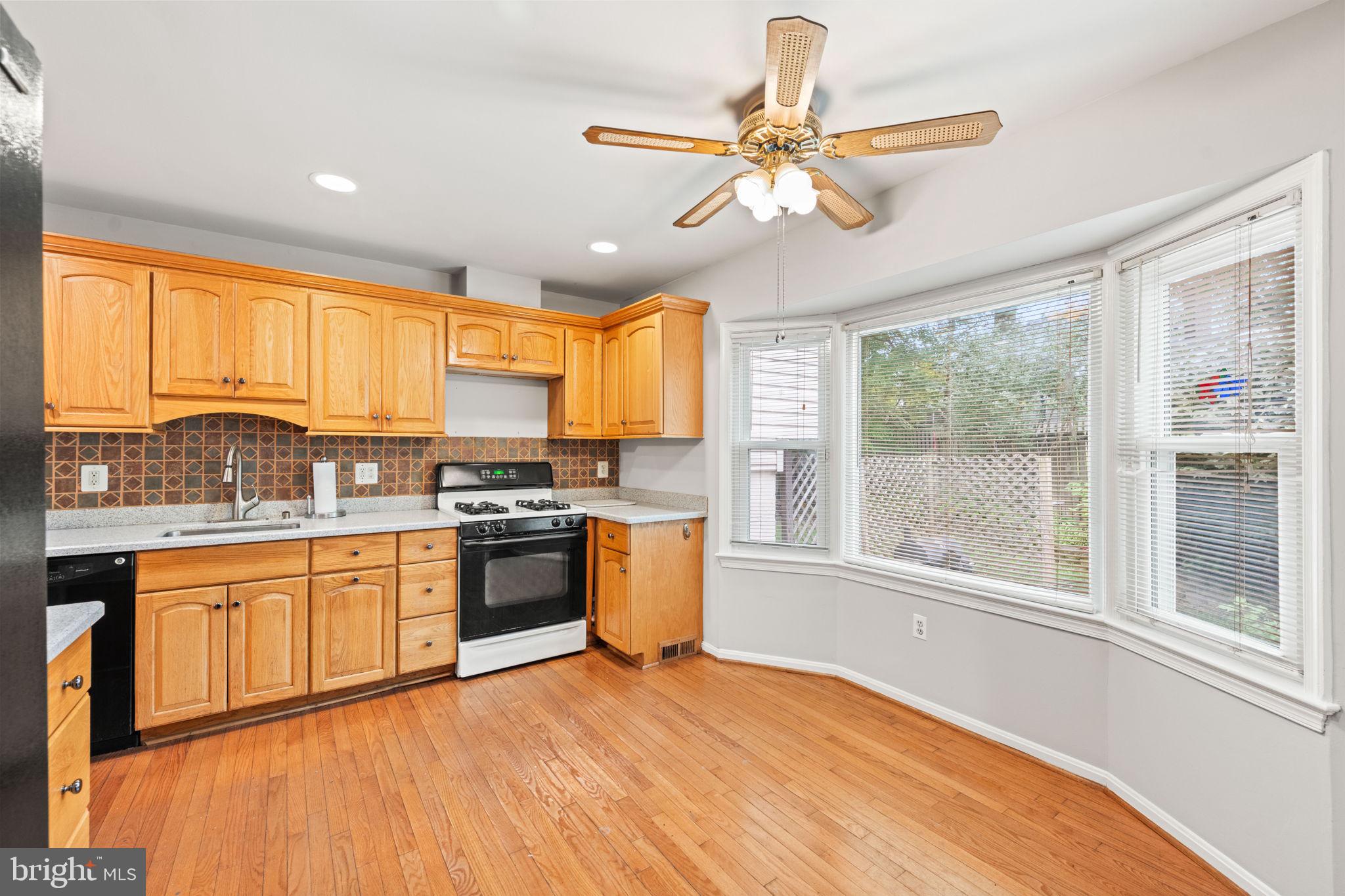 8000 Lady Lewis Court Springfield, VA 22153 - Photo 13 of 44 a kitchen with stainless steel appliances granite countertop a stove and a refrigerator