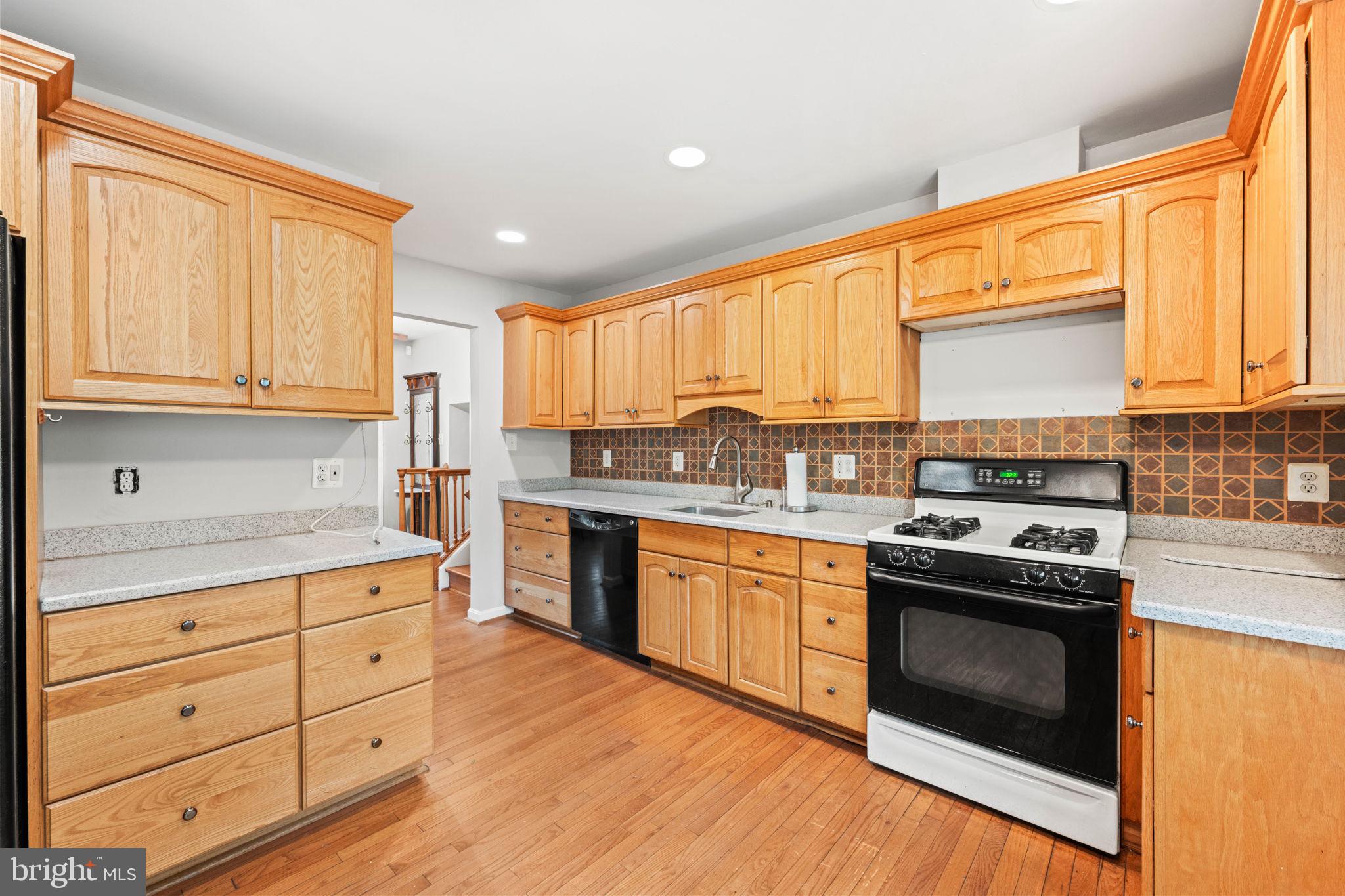 8000 Lady Lewis Court Springfield, VA 22153 - Photo 14 of 44 a kitchen with a stove a sink and a microwave