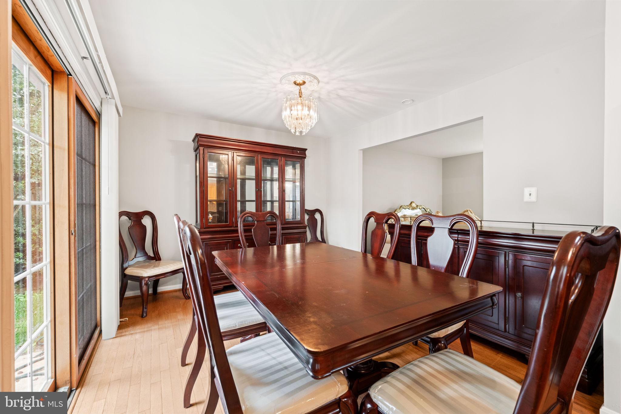 8000 Lady Lewis Court Springfield, VA 22153 - Photo 17 of 44 a dining room with furniture a chandelier and wooden floor