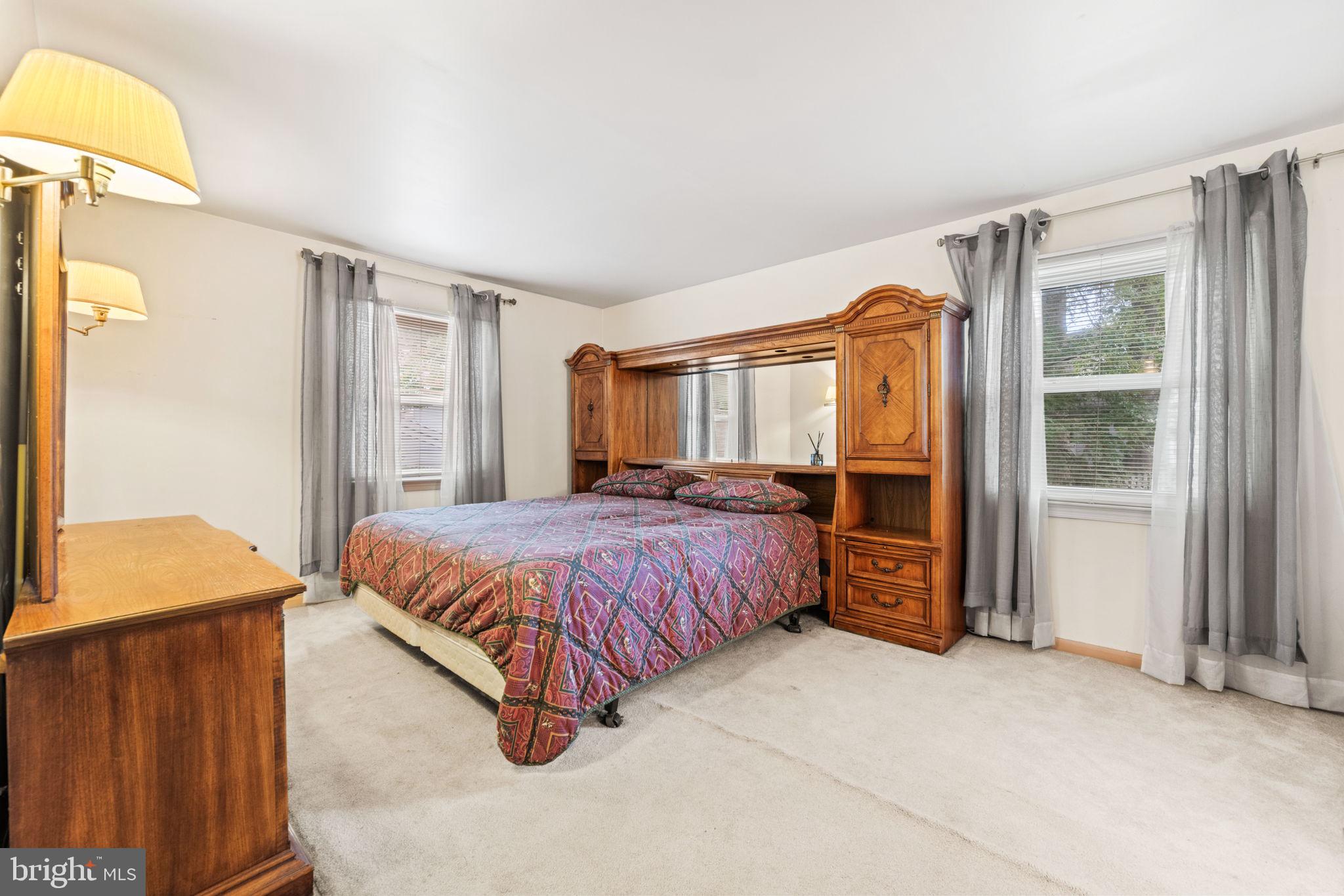 8000 Lady Lewis Court Springfield, VA 22153 - Photo 24 of 44 a spacious bedroom with a bed and a dresser