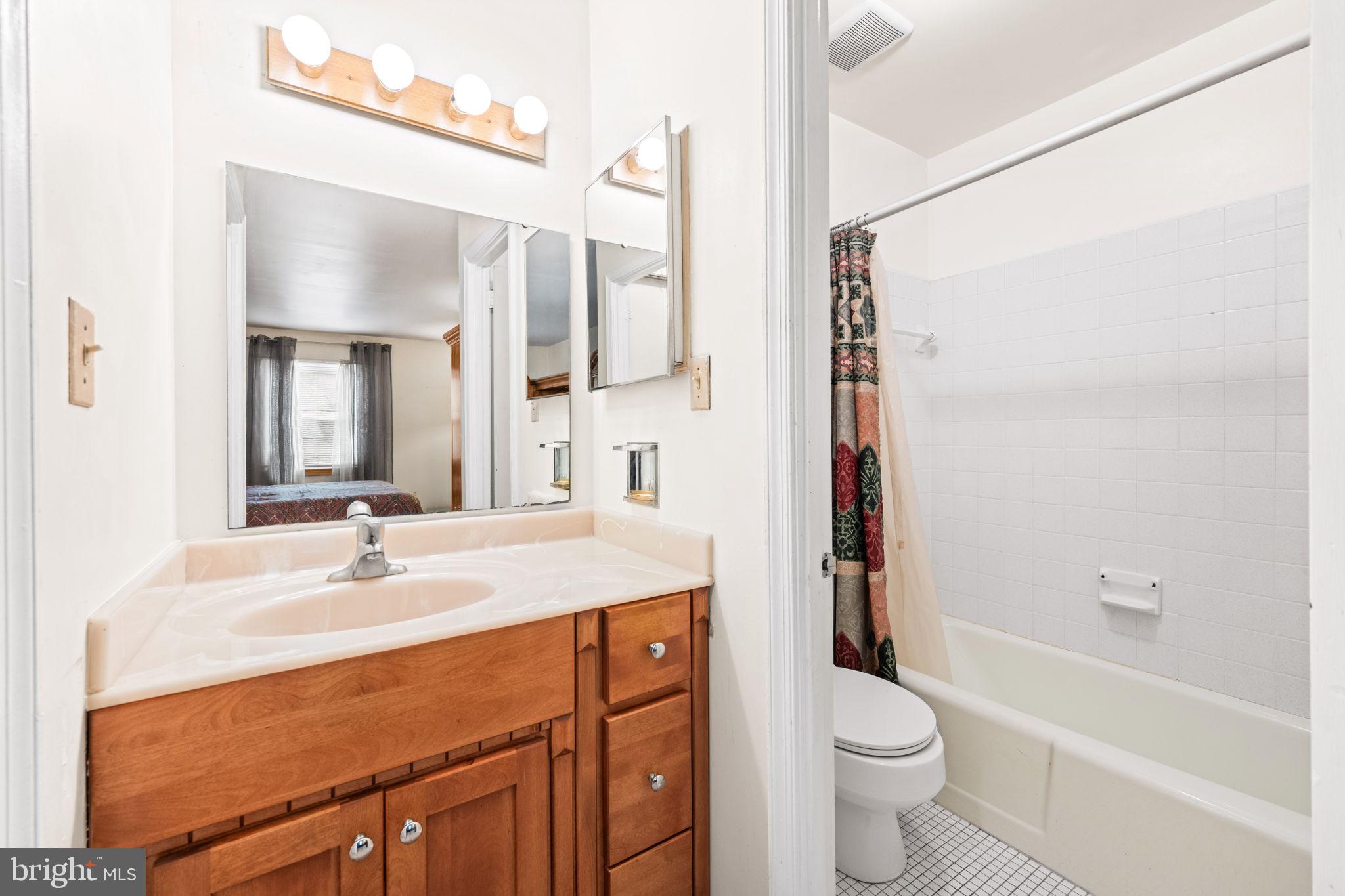8000 Lady Lewis Court Springfield, VA 22153 - Photo 26 of 44 a bathroom with a sink a toilet a mirror and shower