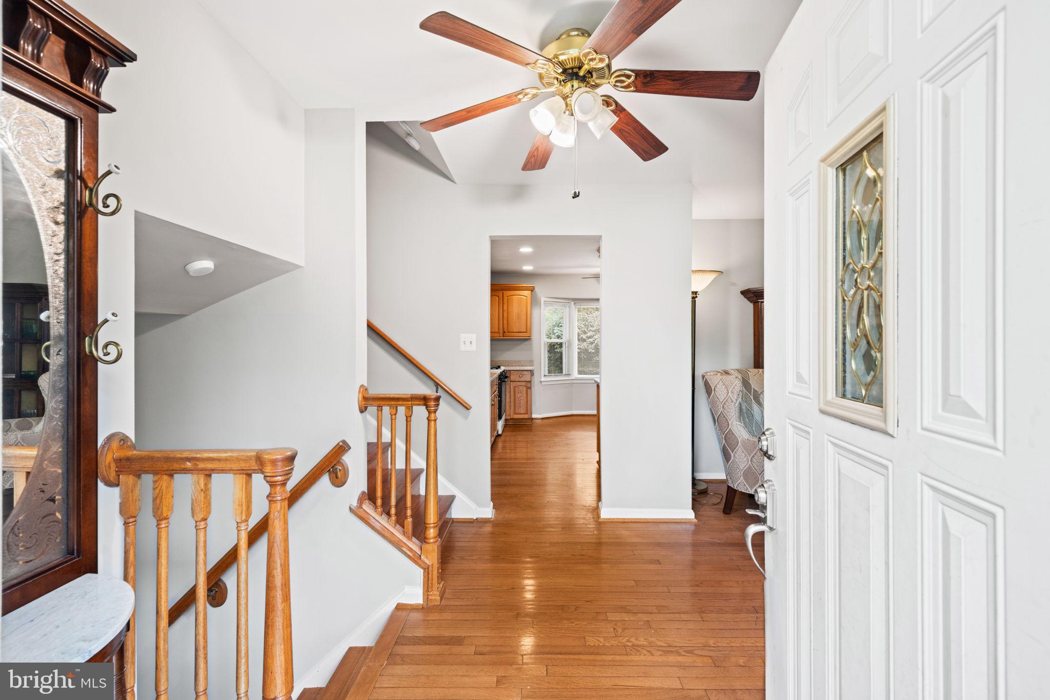 8000 Lady Lewis Court Springfield, VA 22153 - Photo 3 of 44 a view of a hallway with wooden floor and staircase